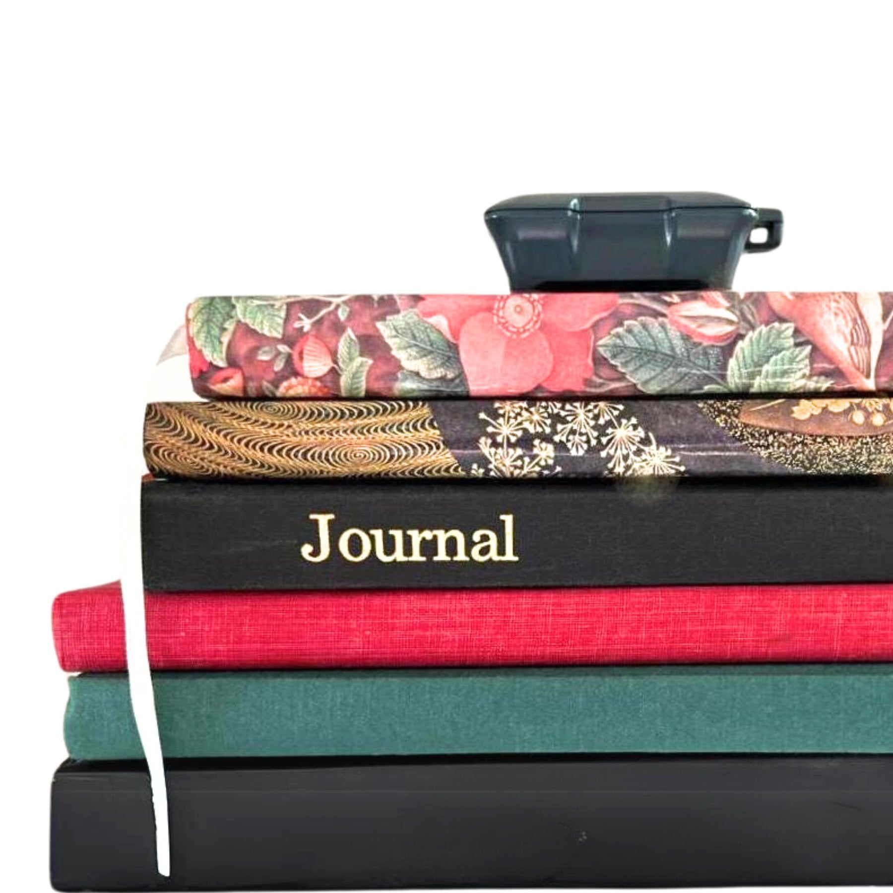 Gray Kini on top of stack of Journals  (Mobile)